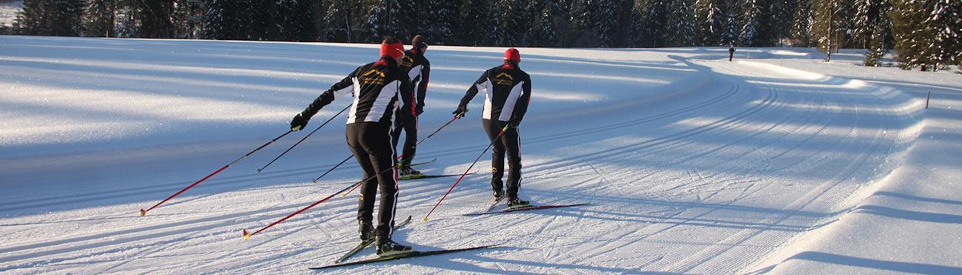 Three winter sports enthusiasts attend the private cross-country skiing lessons for all levels - skating at the Schneesportschule Balderschwang
