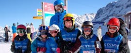 A group of kids smiling during their kids ski lessons for all levels with skischule Altitude in Grindelwald and Wengen.