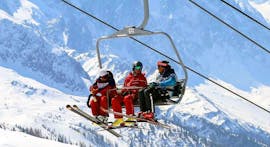 Des skieurs prennent les remontées mécaniques pour rejoindre le haut de la montagne pour leur cours particulier de ski adultes - vacances - tous niveaux avec l'école de ski ESF Vallorcine.