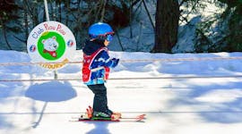 Child is being dragged up to the top of the hill by the ski lift during his Private Ski Lessons for Kids - Holidays - All Levels with the ski school ESF Vallorcine.