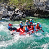 Participants in a boat in the beautiful water during the Whitewater Rafting on the Soča River in Bovec from Nature's Ways Bovec.