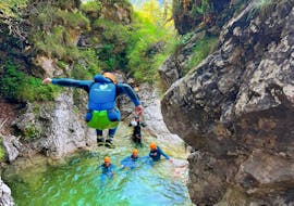 A participant jumping in the water during Canyoning in the Fratarica Gorge near Bovec from Nature's Ways Bovec.