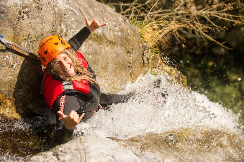 A girl smiles at the camera during the Canyoning Adventure in the Palvico from Arco at Lake Garda with Mmove - Into Nature Garda Lake.