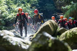 Participants are hiking a river during the Canyoning Adventure in the Palvico from Arco at Lake Garda with Mmove - Into Nature Garda Lake.