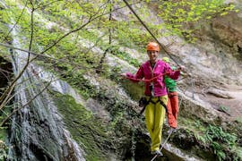 A participant is walking on a rope during the Via Ferrata Rio Sallagoni at Lake Garda for Beginners with Mmove - Into Nature Garda Lake.