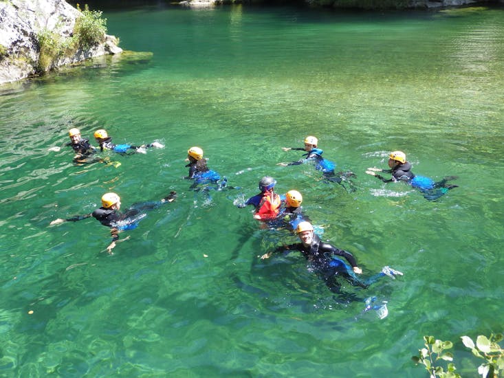 A group of people are following their guide during their canyoning river trekking "fun" at the Canyon Pas de Soucy with B&ABA Sport Nature.