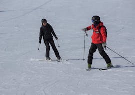 Een skileraar van Ski- und Snowboardschule Vacancia geeft zijn leerling uitleg tijdens een privéles skiën voor volwassenen.