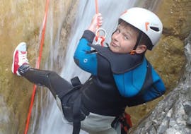 A kid is enjoying his Canyoning in Canyon d'Airole for Families activity with Maglia Canyoning.