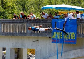 A person is bungee jumping from the Pont de l'Artuby, the highest bridge in France with a 182m height with Latitude Challenge.