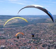 Two persons are enjoying their Tandem Paragliding "XL" - Millau activity with Air Magic Parapente.
