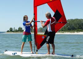Windsurfingkurs "Schnupperstunde" - Heiligenhafen mit Wassersportcenter Heiligenhafen Ein Lehrer vom Wassersportcenter Heiligenhafen erklärt das Windsurfen während der Windsurfing-Schnupperstunde - Heiligenhafen.