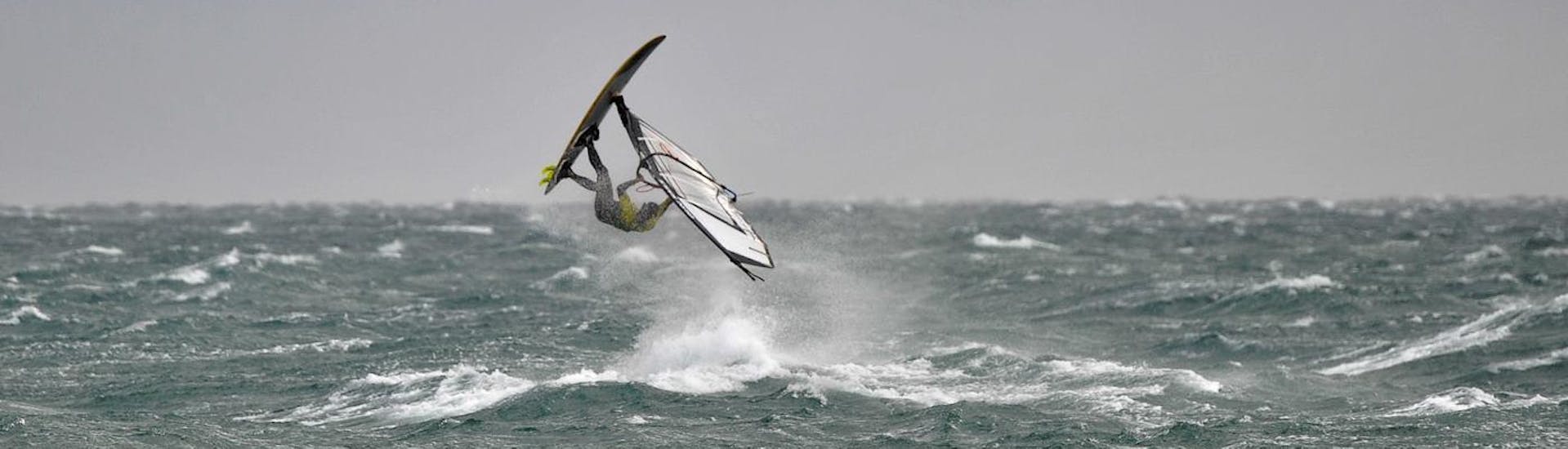 A guy at the sea during a Advanced Windsurfing Lessons (from 8 y.) at Školjić Beach with Windsurf Station Premantura.