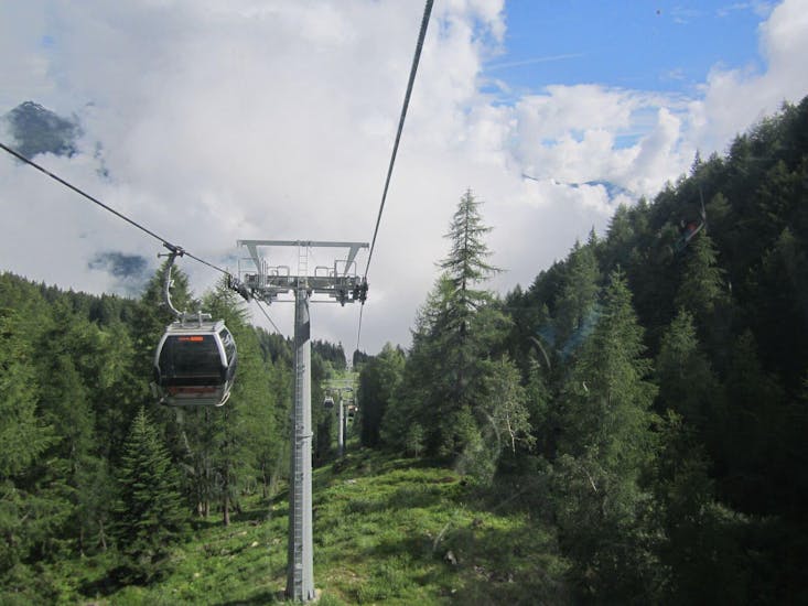 A beautiful gondola lift takes participants at the starting point of the Intermediate Mountain Bike Downhill Tour in Val di Sole.