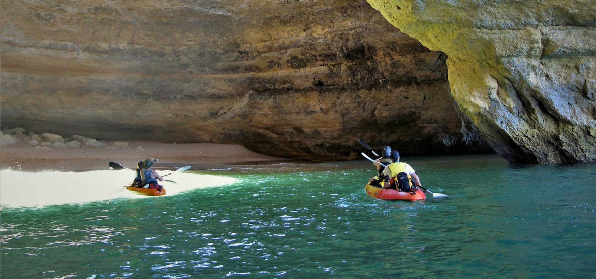 A group of kayakers is paddling into the Benagil Cave during their Boat and Kayak Tour - Benagil Cave with Seasiren Tours.