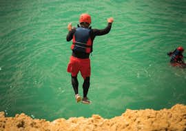 Coasteering in Albufeira - Coastal Adventures with Albufeira Surf & SUP A man jumping into the water while Coasteering in Albufeira - Coastal Adventures with Albufeira Surf & SUP.