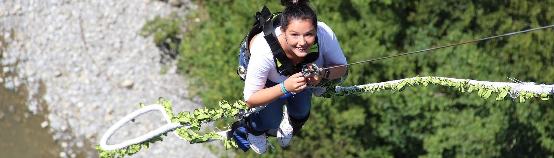 A woman Bungee Jumping from Lingenau Bridge (106m) with HIGH 5 outdoor Vorarlberg.