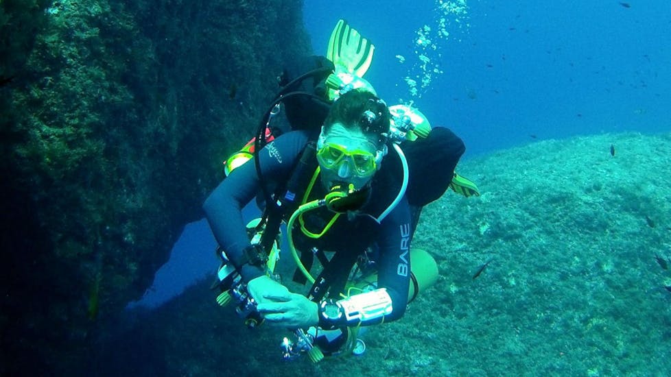 A scuba diver exploring a reef.