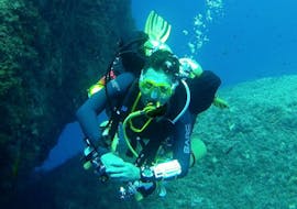 A scuba diver exploring a reef.