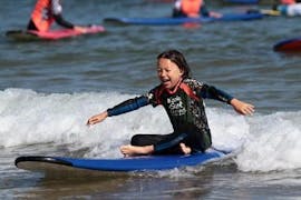 A kid is having fun during Surfing Lessons - Hendaye Beach - Beginner activity with Gold Coast Hendaye.