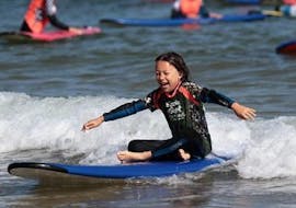 A kid is having fun during Surfing Lessons - Hendaye Beach - Beginner activity with Gold Coast Hendaye.