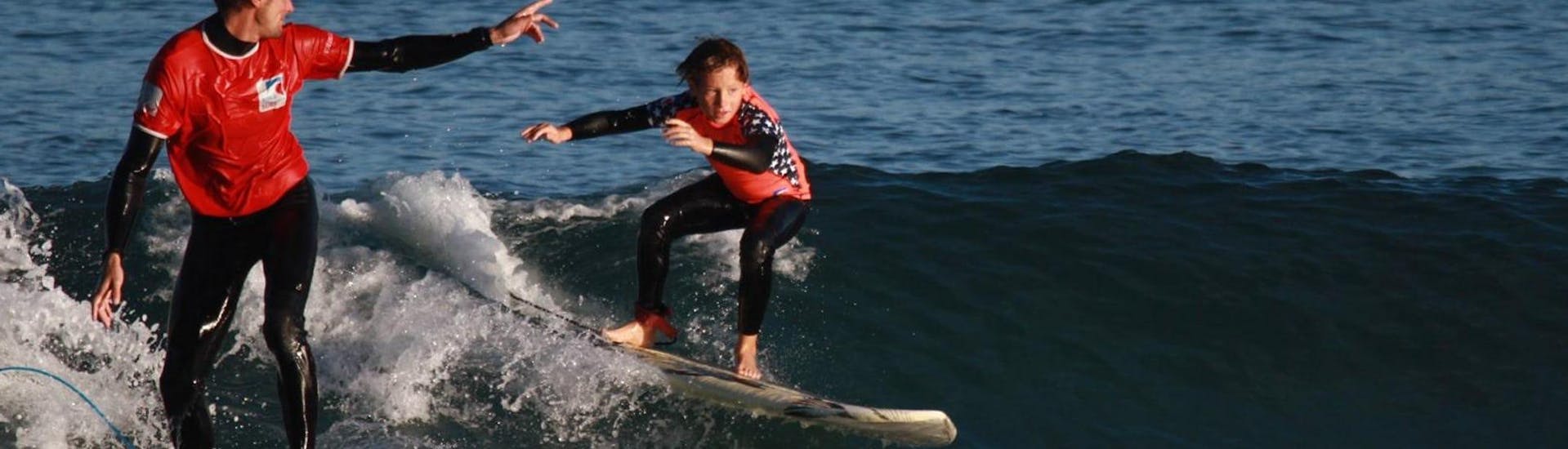 A kid is surfing during Surfing Lessons - Hendaye Beach - Advanced activity operated by Gold Coast Hendaye.