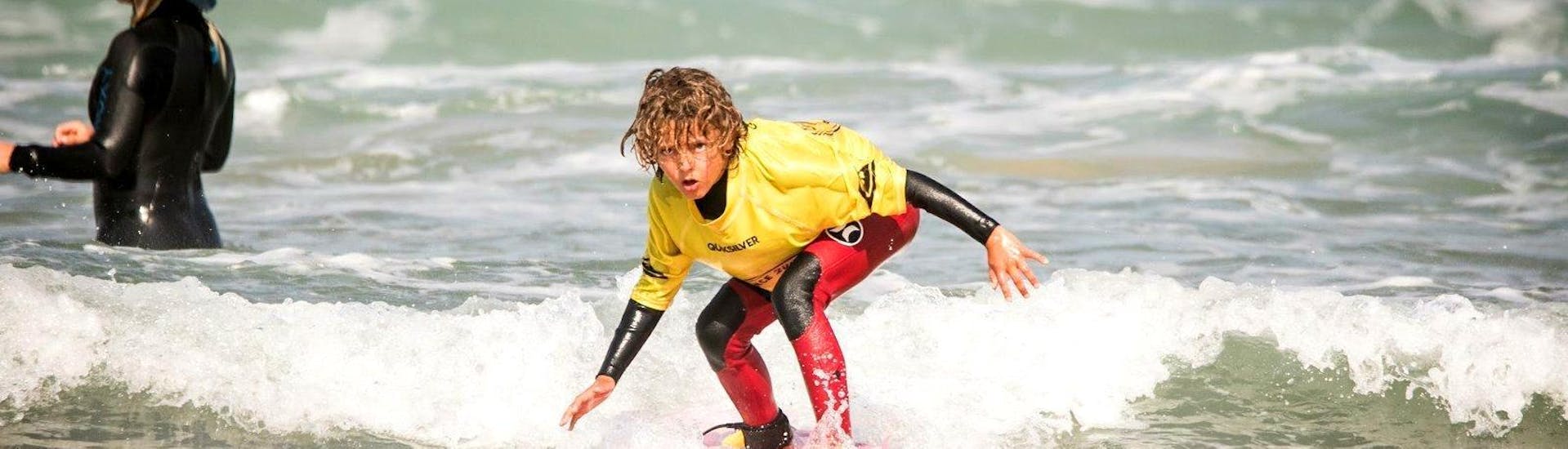 A boy enjoying his Private Surf Lessons (from 5 y.) at Guincho Beach in Cascais.