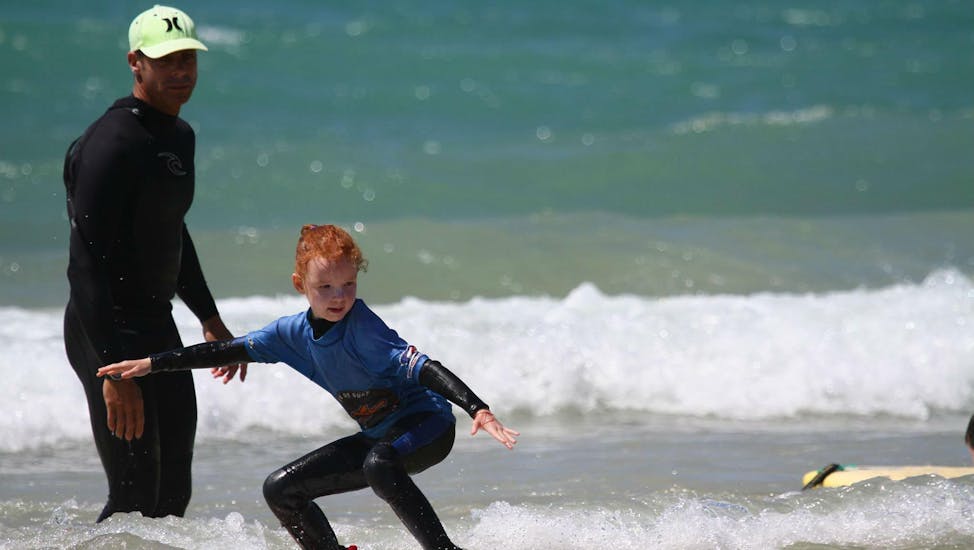 Un enfant effectue un cours de surf privé sur la Plage Sud à Hossegor en basse saison avec un moniteur de Tao Magic Glisse.