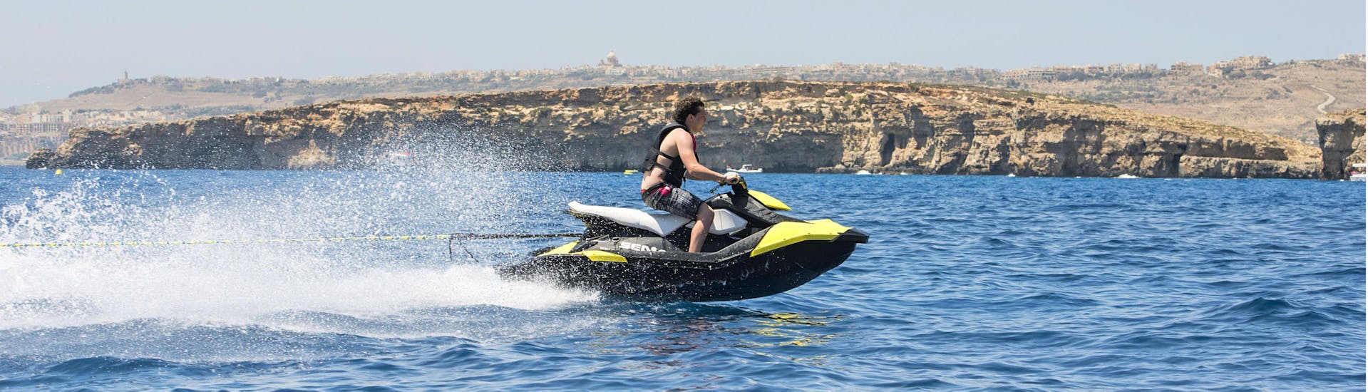 A person riding a jetski during a Jet Ski Safari around Comino & South of Gozo with Palm Beach Water Sports Malta.