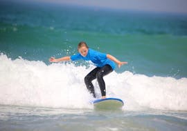 Un enfant surfe une vague sur la plage de la Madrague à Anglet.