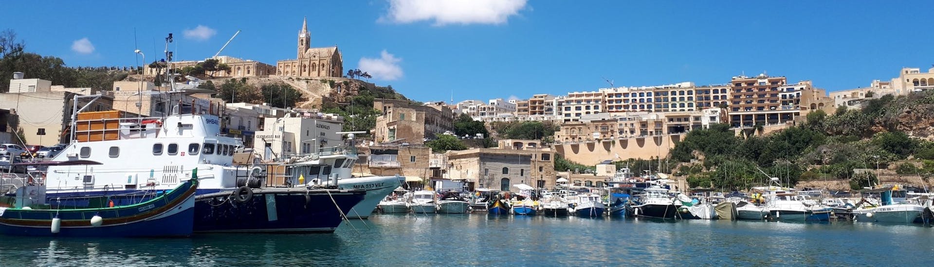 The beautiful harbor of Gozo photographed by boat during the Speedboat Trip to Blue Lagoon & Sightseeing Bus Tour on Gozo.