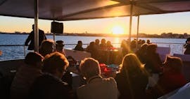 Menschen betrachten den Sonnenuntergang bei der Bootstour rund um Marina de Valencia bei Sonnenuntergang mit Boramar Valencia