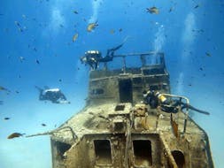 Two divers are exploring the surroundings of a shipwreck during the Wreck Diving around Malta for Certified Divers with DiveWise Malta.