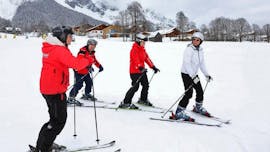 An instructor and adults skiers on the slopes during Adult Ski Lessons "Easy Learning" for Beginners with ski school Ramsau.