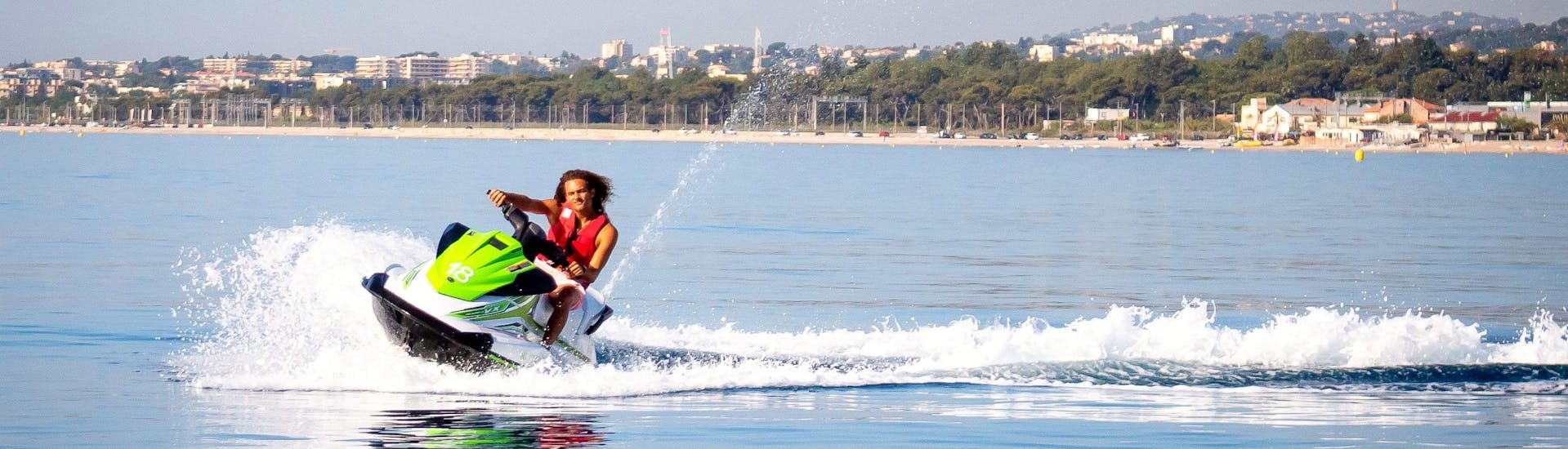 A man is having fun while jet skiing during his Jet Ski Tour in Villeneuve-Loubet with Plage des Marines.
