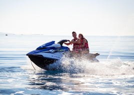 A couple is going full speed during their Jet Ski Tour in Villeneuve-Loubet with Plage des Marines.