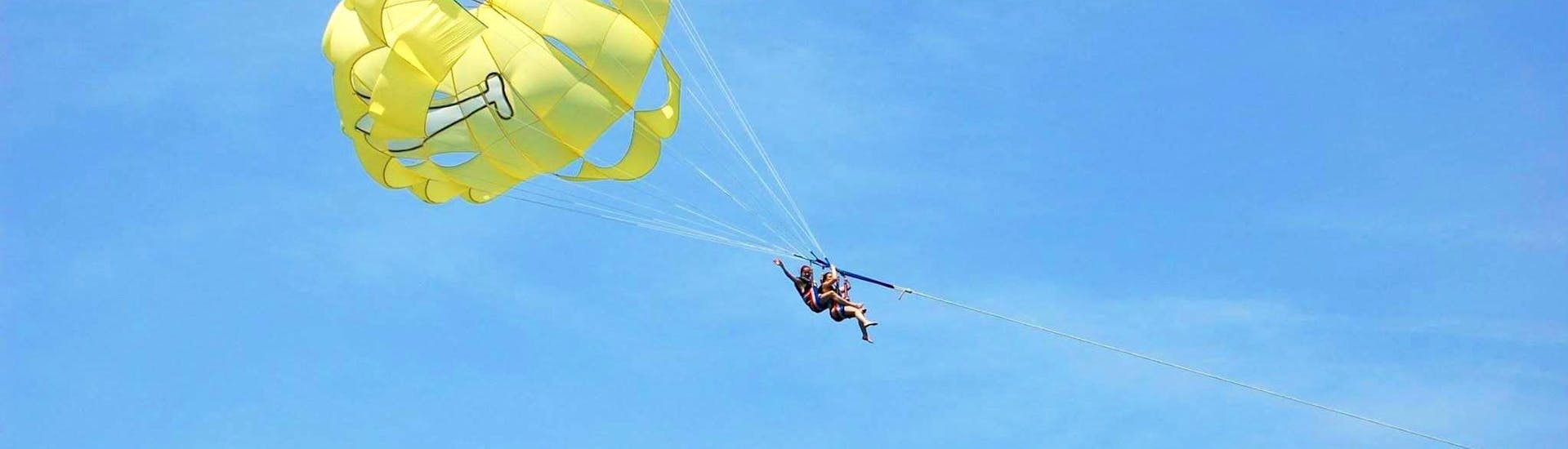Friends are having fun while Parasailing in Villeneuve-Loubet with Plage des Marines.