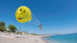 Friends are taking off from the beach while starting Parasailing in Villeneuve-Loubet with Plage des Marines.