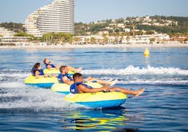 Friends are having fun on their ride with an Inflatable Boat in Villeneuve-Loubet with Plage des Marines.