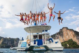 A group of guys jumping off the deck during the private boat trip from Torre de Belém with Swimming with Rent a Boat Lisbon.