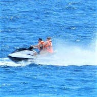 Two participants of a Jet Ski Tour in Benidorm are riding some waves during the activity organized by Carlos Water Sports Benidorm.