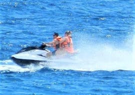 Two participants of a Jet Ski Tour in Benidorm are riding some waves during the activity organized by Carlos Water Sports Benidorm.