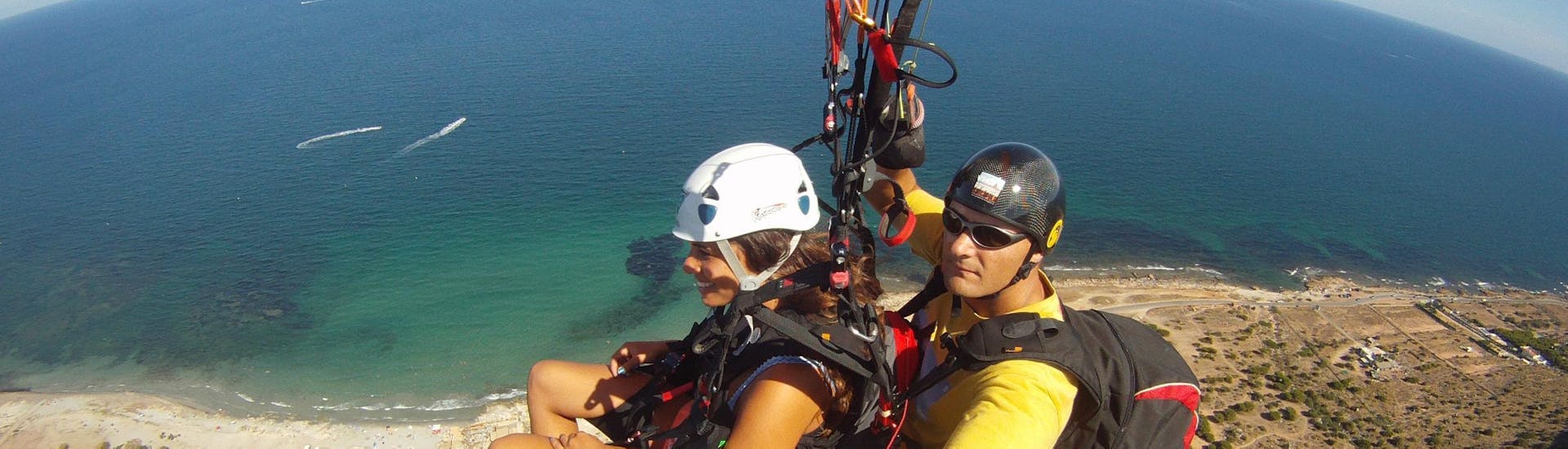 A young girl is doing the Tandem Paragliding at Costa Blanca - Panorama Flight with Parapente Santa Pola.