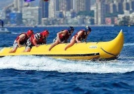 Some participants of the Banana Boat Ride organized by Carlos Water Sports Benidorm are enjoying their time in the sea in Benidorm.