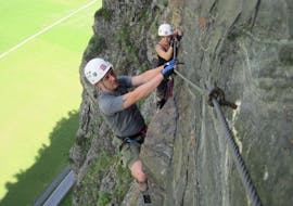 A man and a woman are climbing up the Burgsteiner Wand while on a Via Ferrata in the Ötztal Valley - 'Burgsteiner Wand' with CanKick Ötztal.