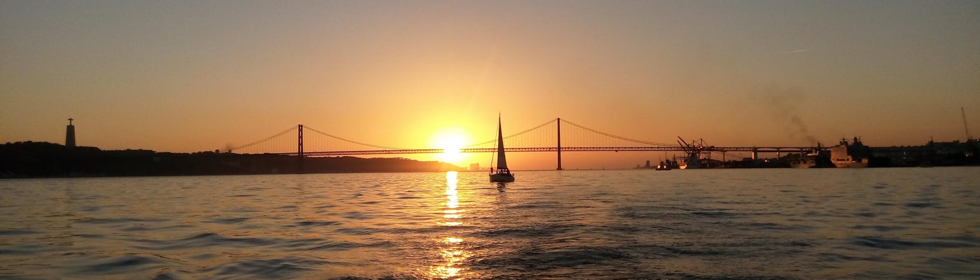 A boat in the water during the Sunset Sail tour on the Tagus
