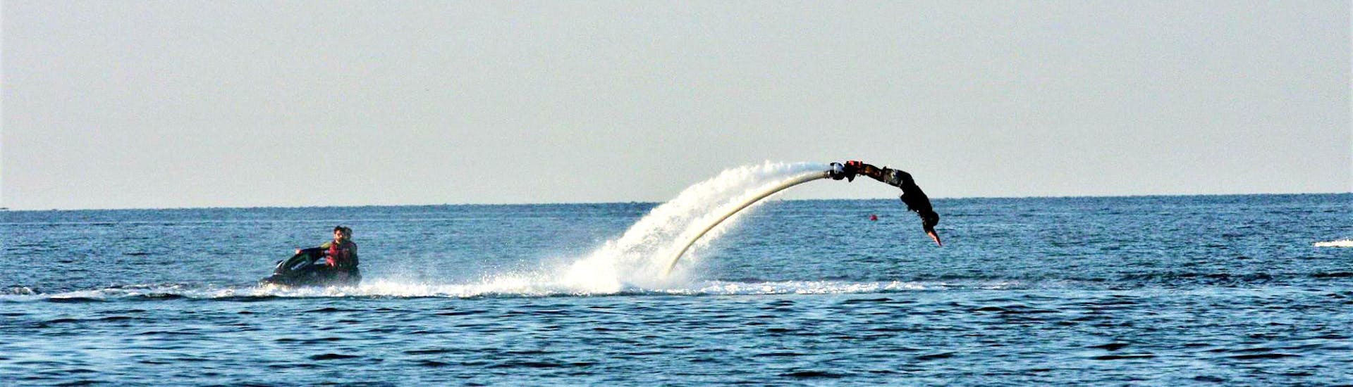 A customer from the Gliss1Flo Watersport Centre flyboarding in the beautiful bay of Saint-Florent.