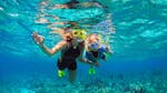 Mother and son snorkeling in the Torrenova Coastline posing for the photo during an activity by Norway Dive Mallorca.