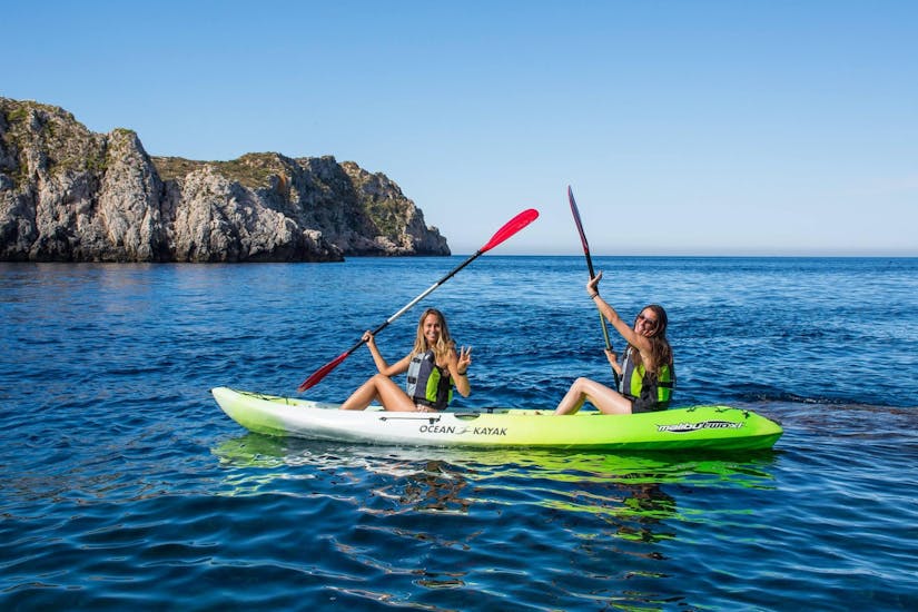 Two participants kayaking in the Malgrats Islands during a guided tour offered by ZOEA Mallorca.