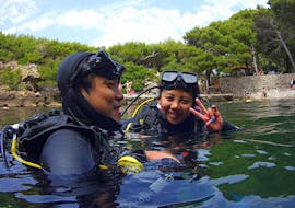 Two divers waving at the camera during their PADI Scuba Diver Course in Dubrovnik for Beginners with Diving Center Blue Planet Dubrovnik.
