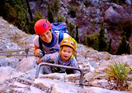 Mother and child climbing during Via Ferrata on Monte Colodri for Families with SKYclimber Tremosine.